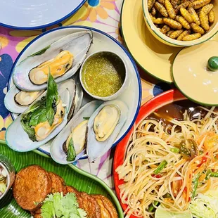 Mussels, worms, isaan style papaya salad &amp; fish cakes