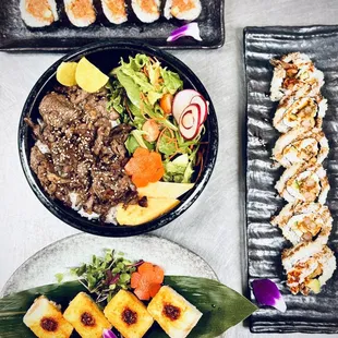 a variety of sushi dishes on a table