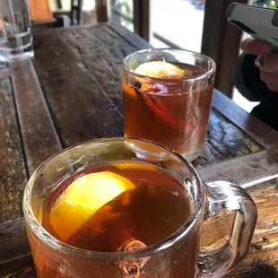 two glasses of tea and a cell phone