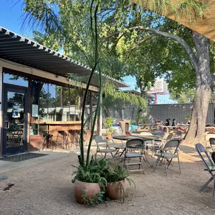 a patio with tables and chairs