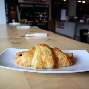 a croissant on a white plate