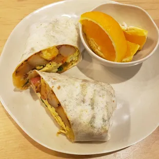 Breakfast burrito with a side of fruit or potatoes