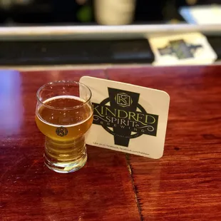 a glass of beer on a bar