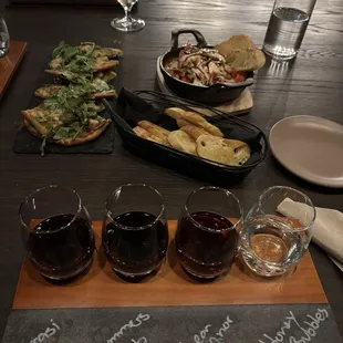 Our wine flight with the food in the background. Far back is the Burrata.