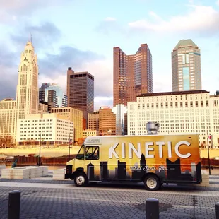 a food truck parked in front of a city skyline