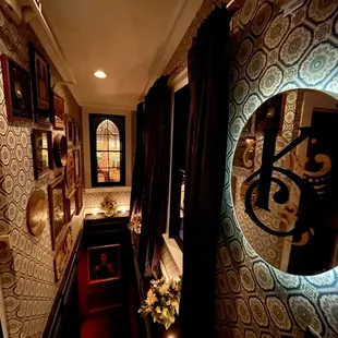 a narrow hallway with a mirror