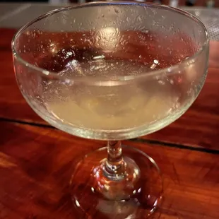 a glass of wine on a wooden table