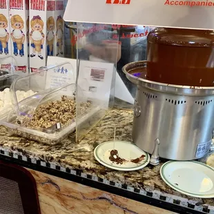 a chocolate fountain and plates of food