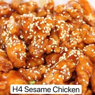 a plate of chicken with sesame seeds