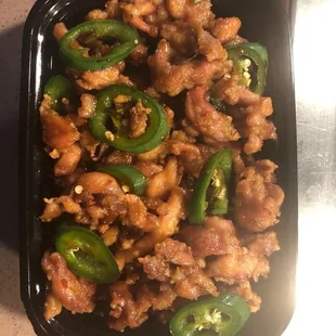 a tray of chicken and jalapenos