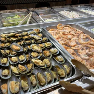 a variety of seafoods in a buffet