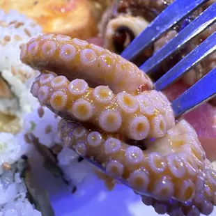 a fork holding a piece of food