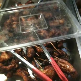 chicken skewers with toothpicks in a container