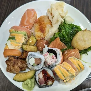 a plate of sushi and vegetables