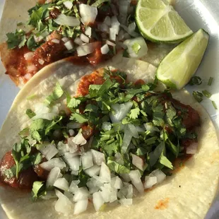 two tacos on a paper plate