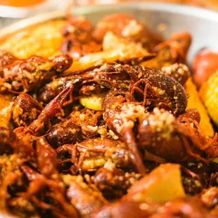 a bowl of crawfish and corn