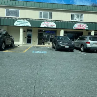 a parking lot with cars parked in front of it