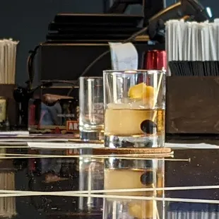 a glass of whiskey on a bar