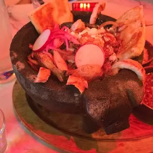 Molcajete (skirt steak, chicken, shrimp, chorizo, tomatillo sauce,  grilled cambray onions, cheese quesadilla, queso fresco)