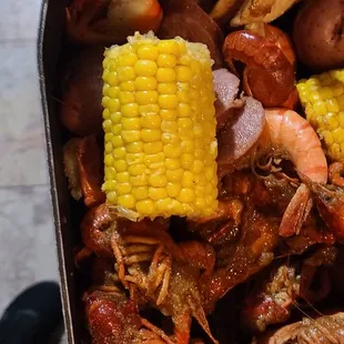 crab legs, corn, potatoes, and corn on the cob
