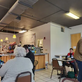 people sitting at tables in a restaurant