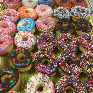 a variety of doughnuts on a cooling rack