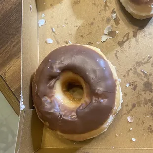 a chocolate frosted donut in a box