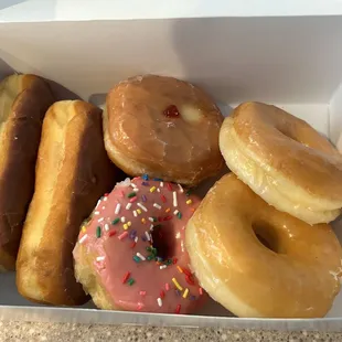 Half dozen (2 glazed, 2 chocolate long johns, strawberry sprinkled, and a jelly)