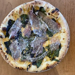 This is a special pizza, garlic cream, Swiss chard, culatello and pecorino romano