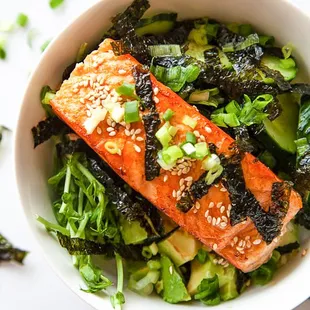 a bowl of salmon and broccoli