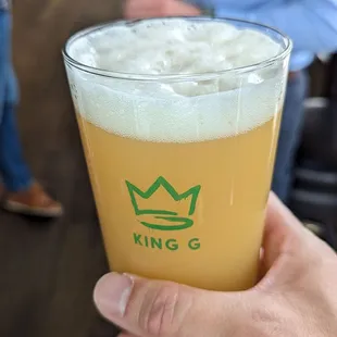 a person holding a glass of beer