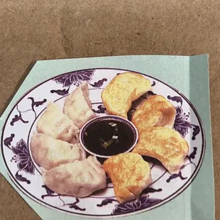 fried or steamed dumplings on a plate