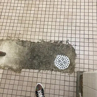 a person standing on a tiled floor