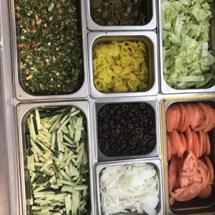 a variety of vegetables in trays