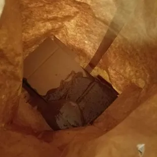 a piece of chocolate in a brown paper bag