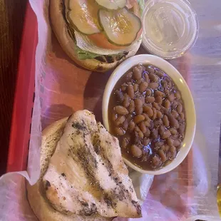 Grilled chicken sandwich and baked beans.