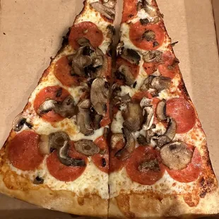 One slice cut in half (pepperoni and mushrooms)