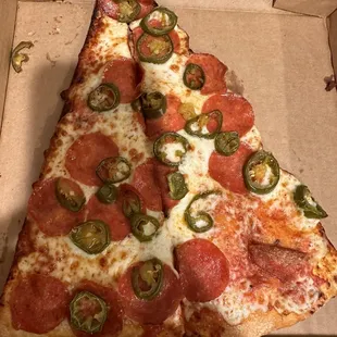 One slice cut in half (pepperoni and jalapeños)