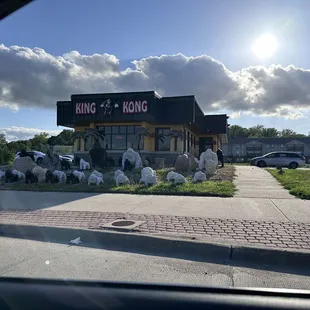a group of sheep in front of a restaurant