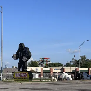 a statue of king kong in the middle of a street
