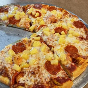 a pizza with pineapple and pepperoni