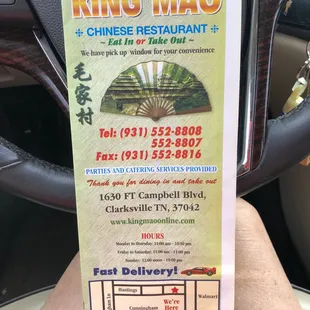 a hand holding a ticket for a chinese restaurant