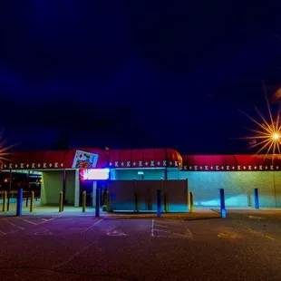 a neon sign in a parking lot
