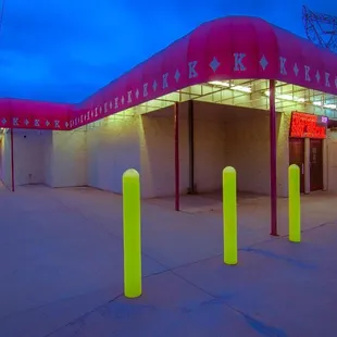 neon poles in front of a building