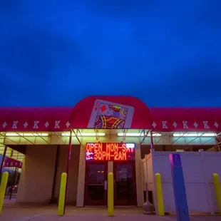 a neon sign in front of a restaurant