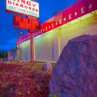 a large rock in front of a building