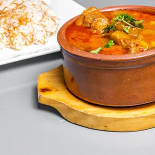 a bowl of stew and a plate of rice