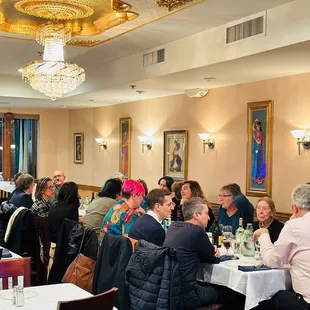 a large group of people sitting at a table