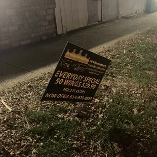 a sign in front of a building