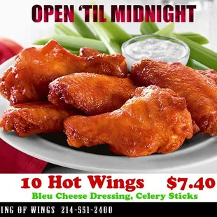 a plate of chicken wings and celery sticks